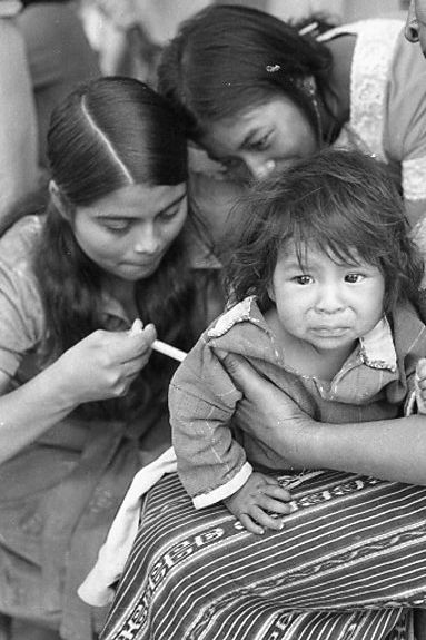 A girl receives medical treatment. B/W